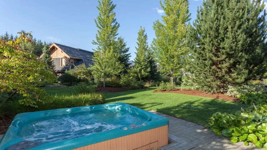 Yard featuring a hot tub and a patio, with stunning views of Blackcomb.