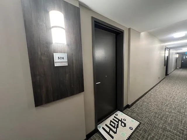 Hall featuring carpet flooring and baseboards