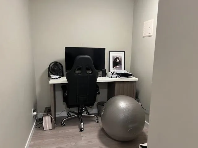 Office space featuring baseboards and wood finished floors