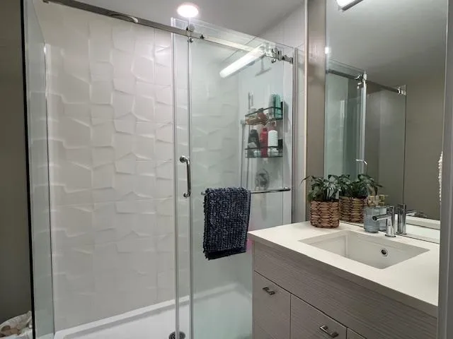 Full bath featuring vanity and a shower stall