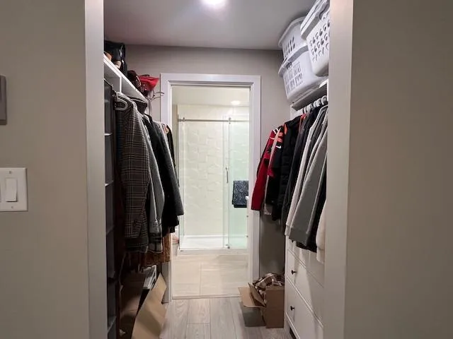 Spacious closet with light wood-style flooring