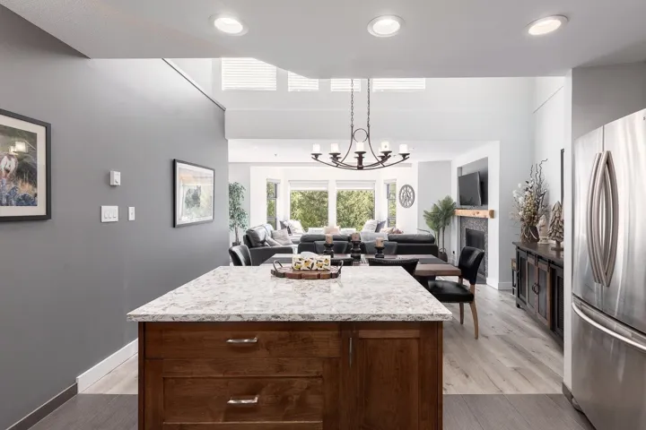 Kitchen island with a granite-style countertop and wood-finish cabinetry