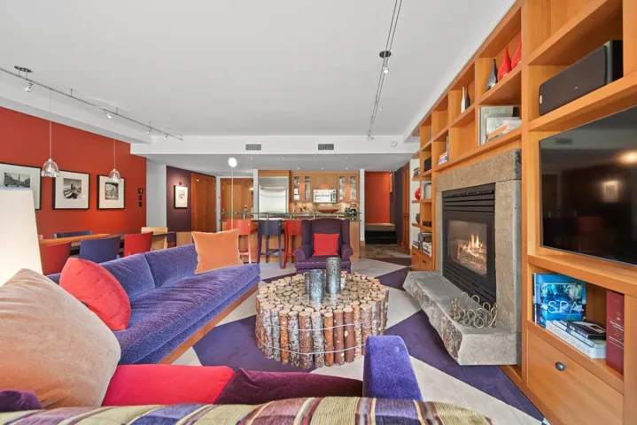 Living area featuring track lighting, built in features, and a tile fireplace