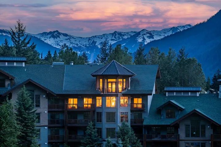 Back of property at dusk with a mountain view, a metal roof, and a standing seam roof