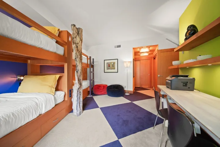 Bedroom with tile patterned floors and a desk