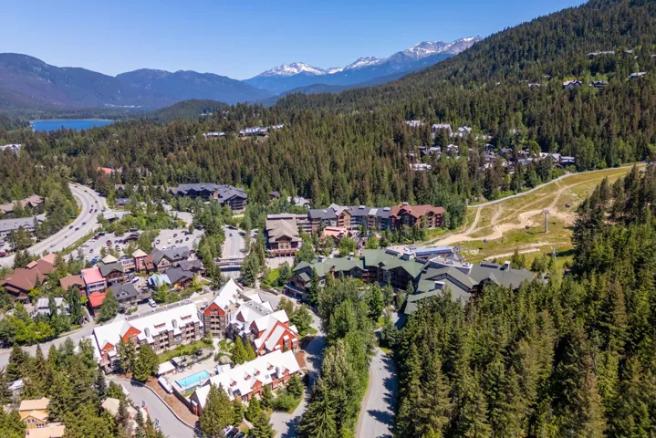 Aerial view of property and surrounding area featuring mountains