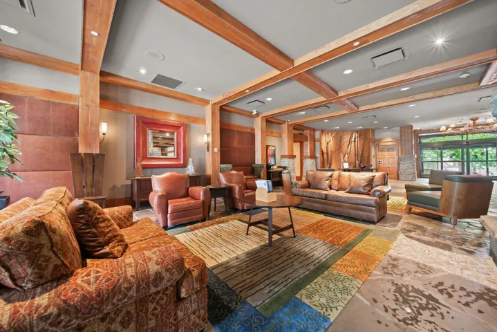 Community lobby featuring beam ceiling and recessed lighting