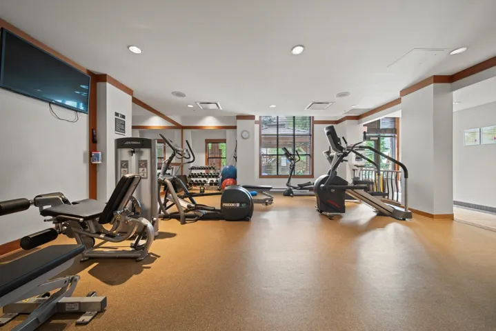 Exercise room featuring recessed lighting and ornamental molding