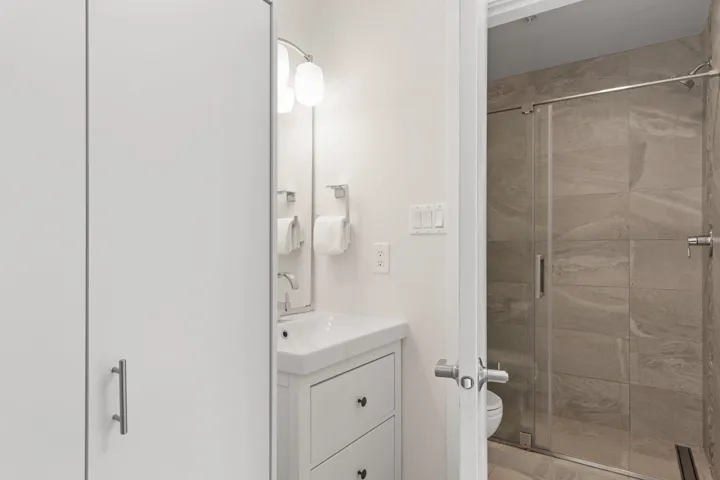 Full bath with a shower stall and vanity