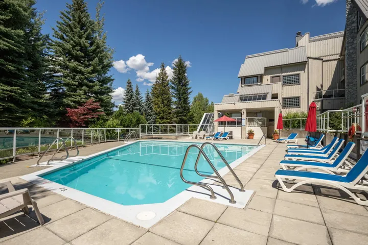 Community pool with a patio