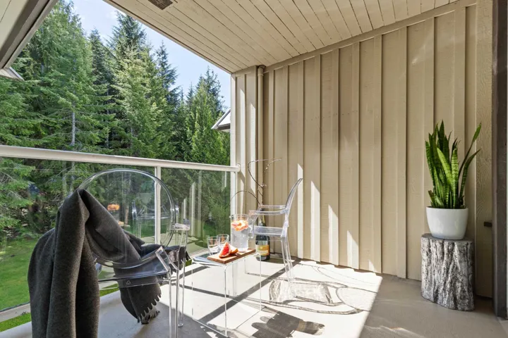Balcony with view of wooded area