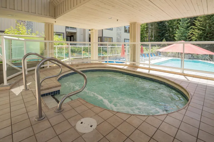 Community pool featuring a hot tub and a patio area