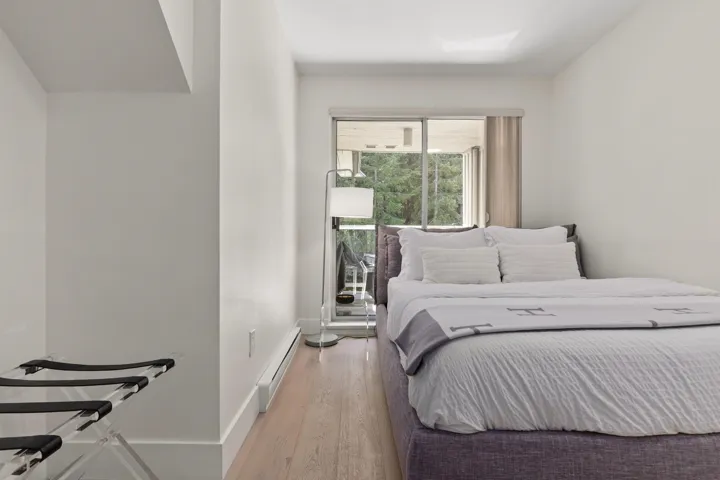 Bedroom featuring light wood-type flooring and a baseboard radiator