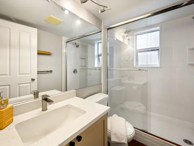 Bathroom with vanity and a stall shower