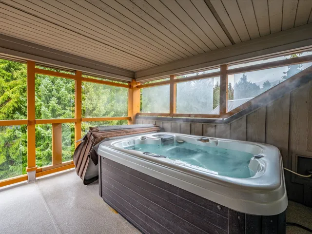 Sunroom featuring a jacuzzi
