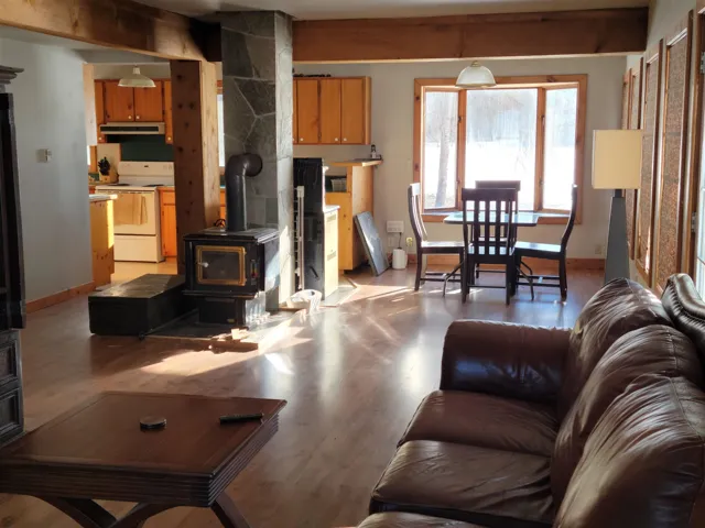 Living room featuring a wood stove and light wood-type flooring