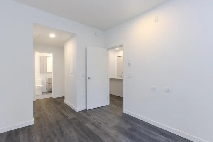 Bedroom leading into walk in closet and ensuite bathroom