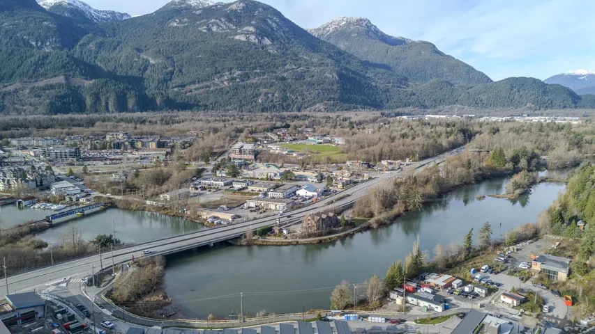 View of mountain backdrop featuring a nearby body of water and a notable bridge
