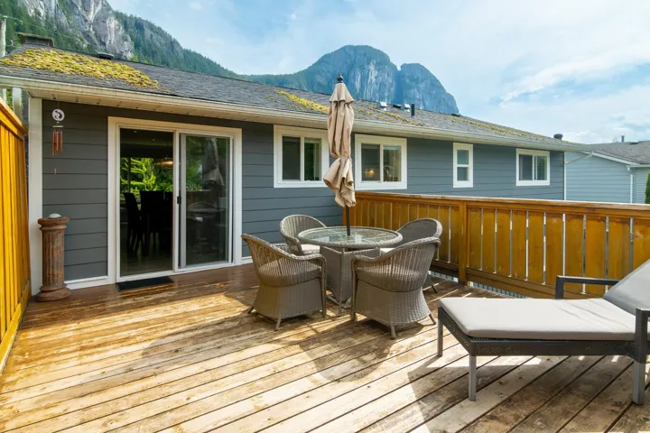 Wooden deck with a mountain view and outdoor dining space