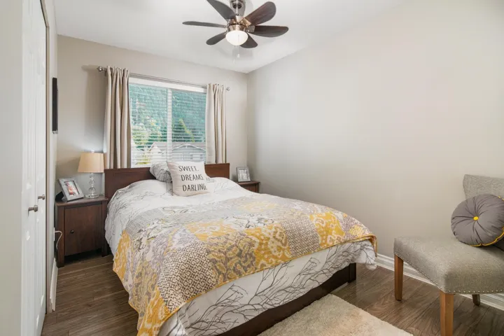 Bedroom featuring wood finished floors, baseboards, and ceiling fan