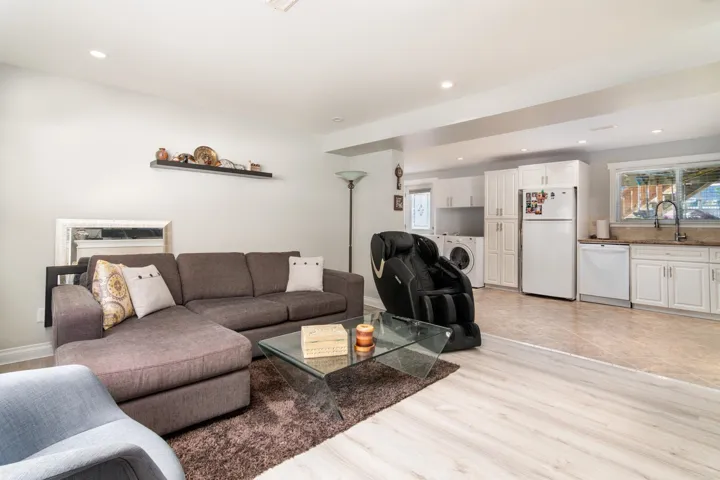 Living area featuring healthy amount of natural light, light wood-style floors, independent washer and dryer, and recessed lighting