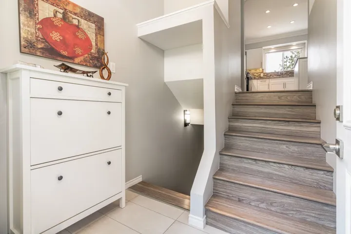 Stairway with tile patterned floors, crown molding, baseboards, and recessed lighting