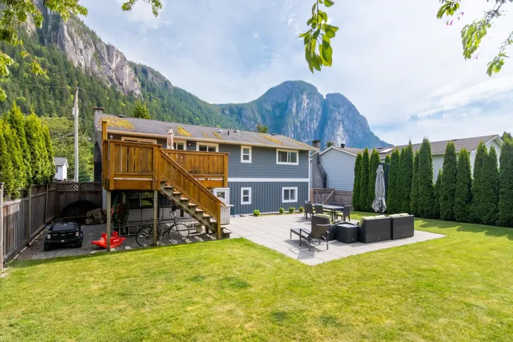 Back of house featuring a patio area, a deck with mountain view, outdoor lounge area, and stairway