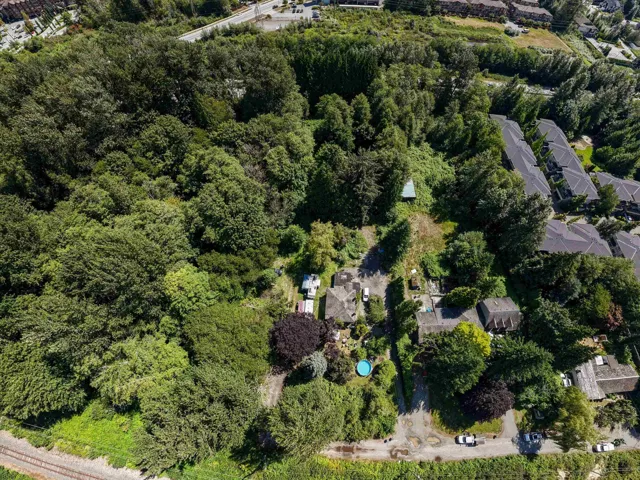 Expansive lot featuring mature trees and established landscaping