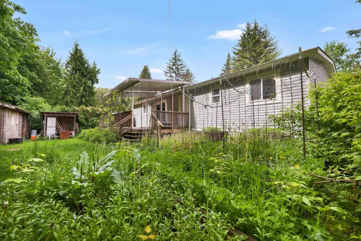 Back of property featuring a wooden deck