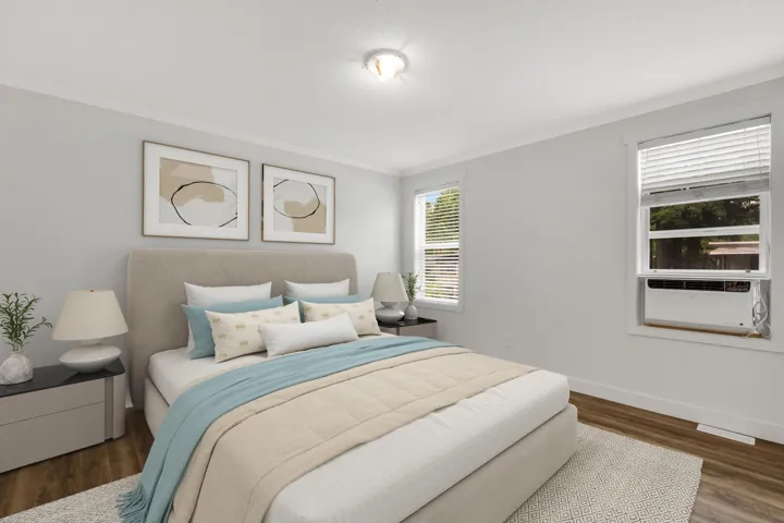 Bedroom with ornamental molding, wood finished floors, and baseboards