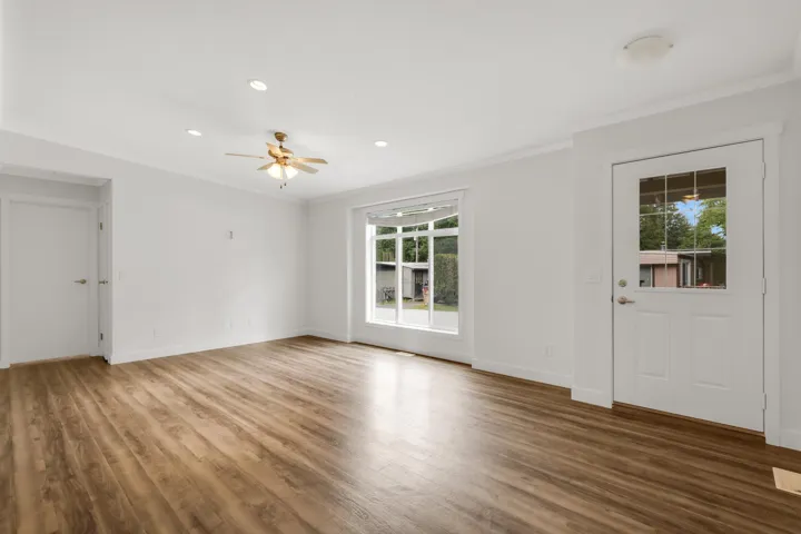 Unfurnished living room with ornamental molding, wood finished floors, ceiling fan, baseboards, and recessed lighting