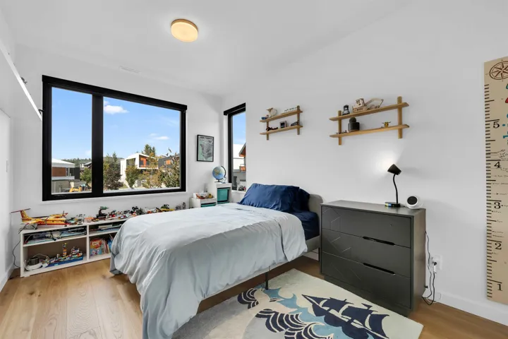 Bedroom with light wood-style flooring and baseboards