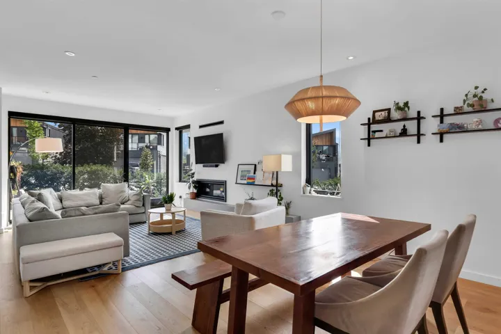 Dining area with light wood-style floors and recessed lighting