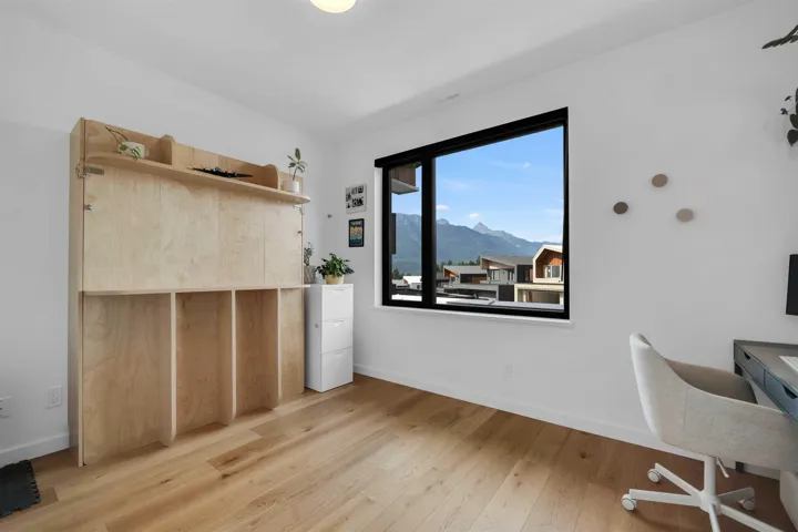 Bedroom with a mountain view and light wood-type flooring