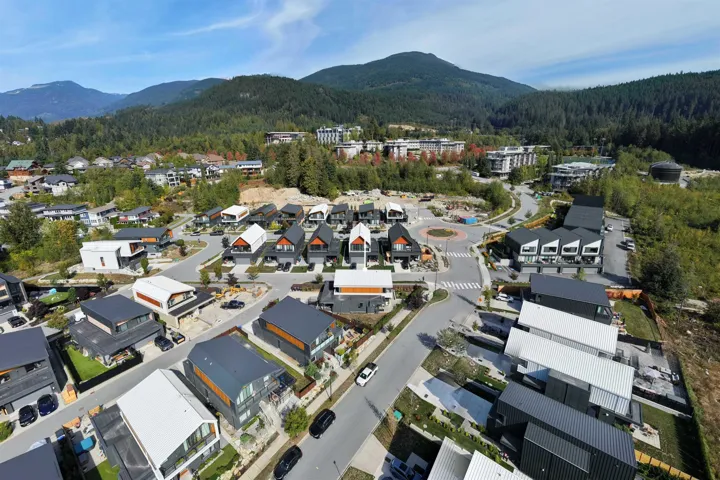 Aerial overview of property's location featuring a forest and nearby suburban area