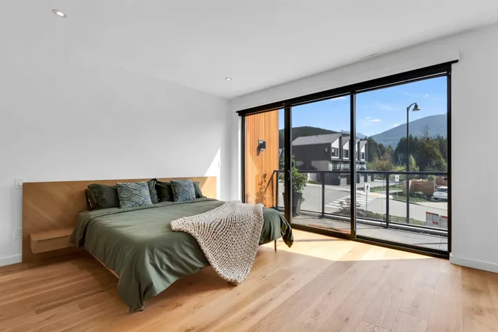Bedroom with a mountain view, light wood-style flooring, access to outside, and recessed lighting