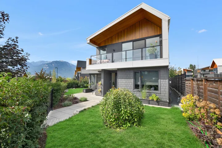 Back of property with a balcony and a mountain view