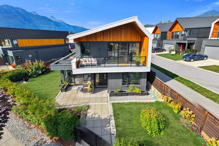 Rear view of house with a balcony, a mountain view, and a residential view