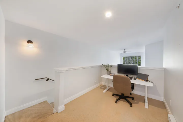 Home office featuring light carpet and baseboards