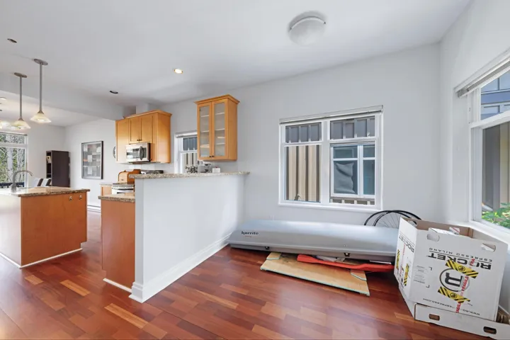 Kitchen with stainless steel appliances, dark wood finished floors, glass insert cabinets, recessed lighting, and a peninsula