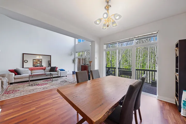 Dining area featuring a chandelier, wood finished floors, and baseboards