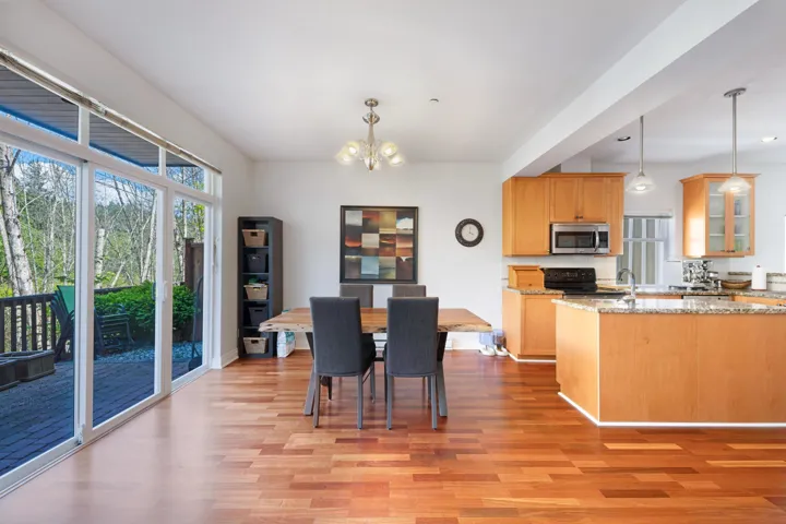Dining area featuring a chandelier, light wood-style flooring, and baseboards