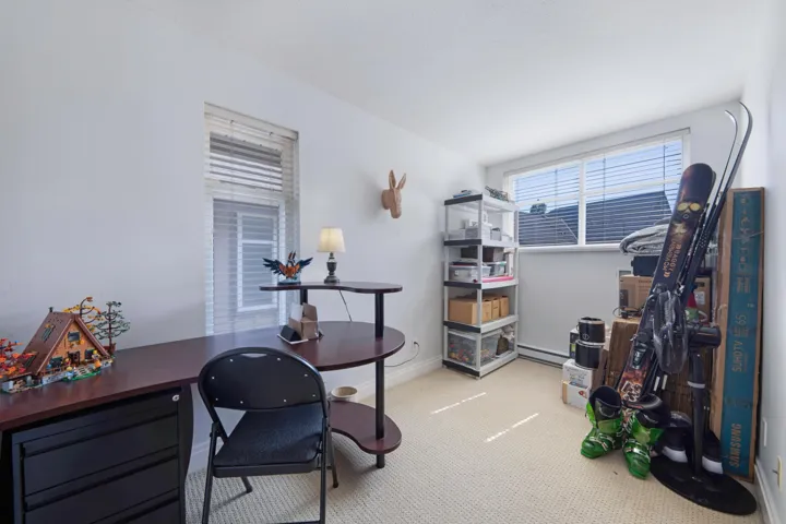 Office space featuring a baseboard heating unit, carpet flooring, and baseboards