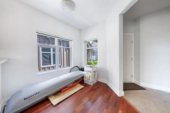 Living area with baseboards and wood finished floors