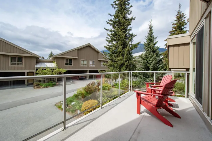Spacious private balcony featuring a glass railing and concrete surface