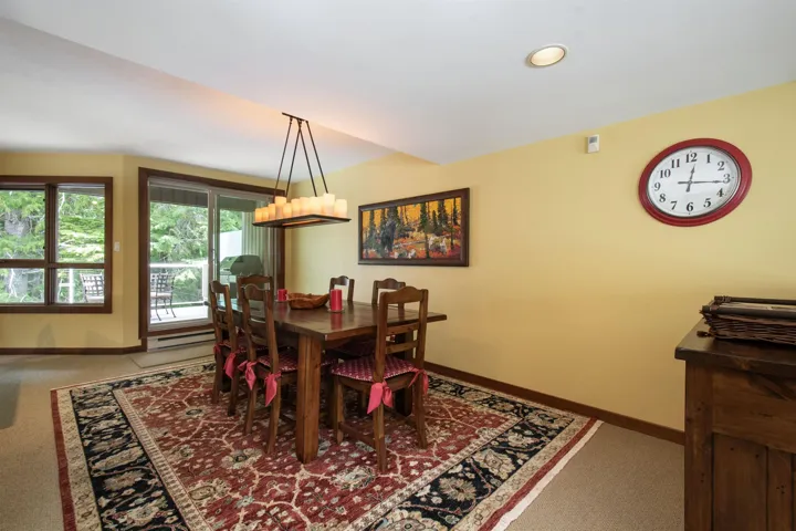 Dining area with recessed lighting and a contemporary chandelier