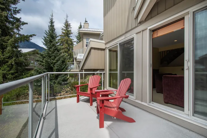Outdoor balcony featuring a glass railing system and durable floor surface