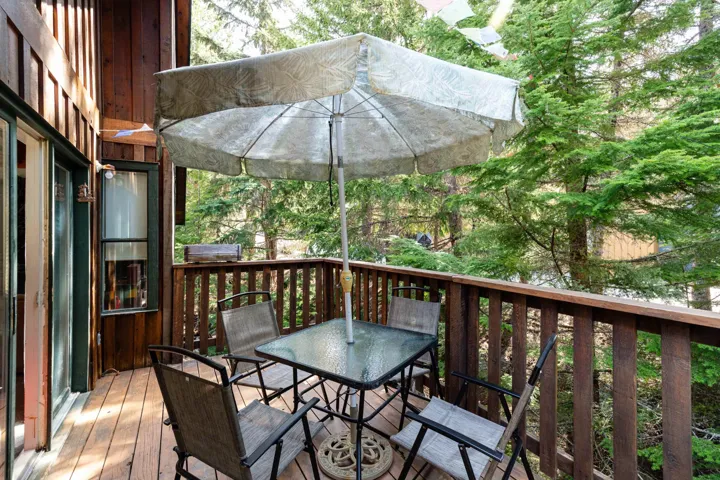 Expansive wood deck with wood plank flooring and vertical wood railing