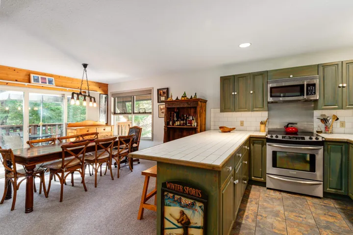 Kitchen featuring wood-finish cabinetry, tile countertops, and stainless steel appliances