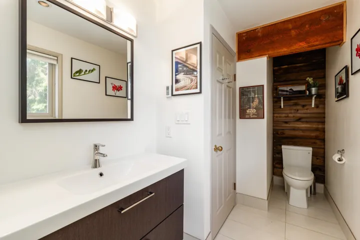 Modern bathroom featuring a contemporary vanity with a rectangular integrated sink, single-handle faucet, and dark wood-finish cabinetry